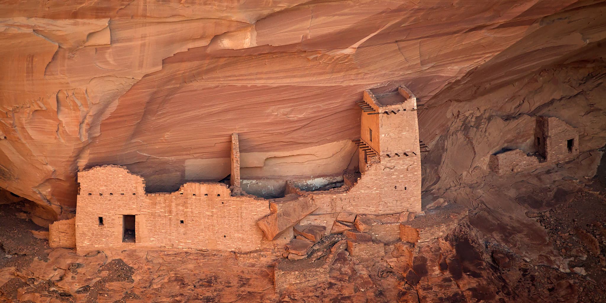 An ancestral Puebloan cliff dwelling built into a sandstone alcove in Canyon de Chelly