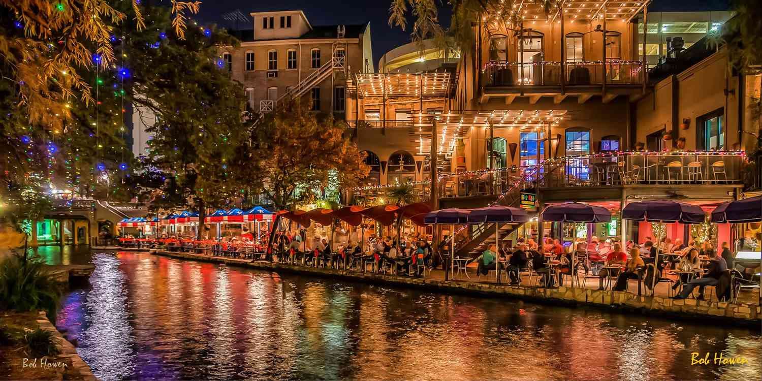 Outdoor dining along the San Antonio River Walk at night